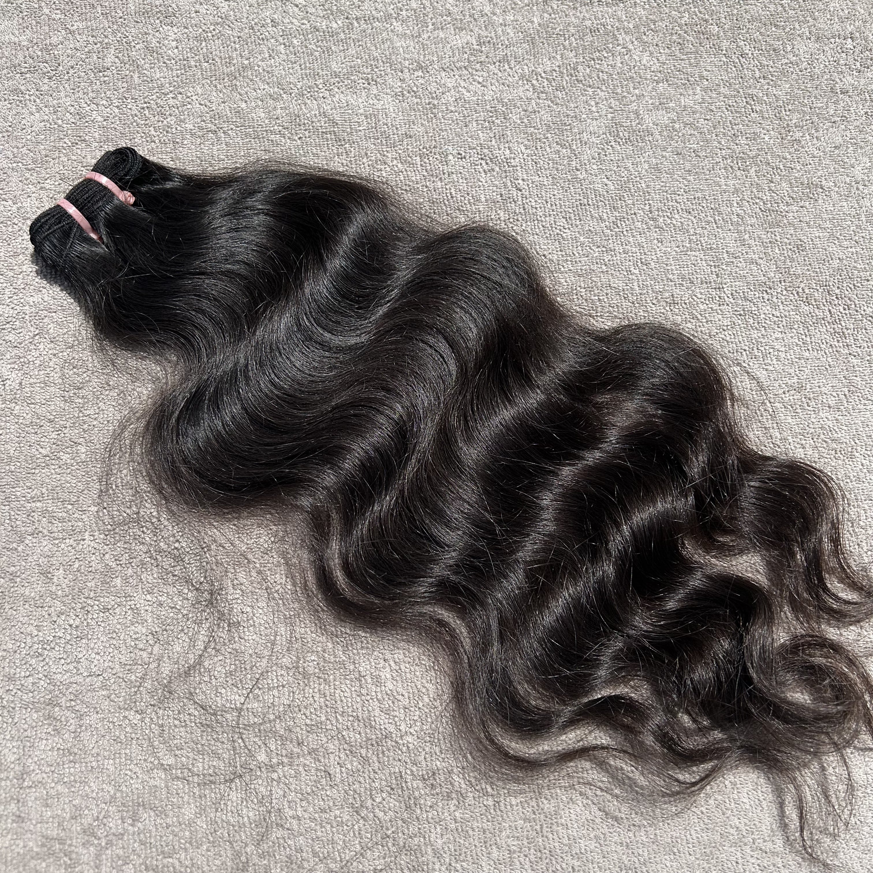 Curly hair bundle on a textured gray surface