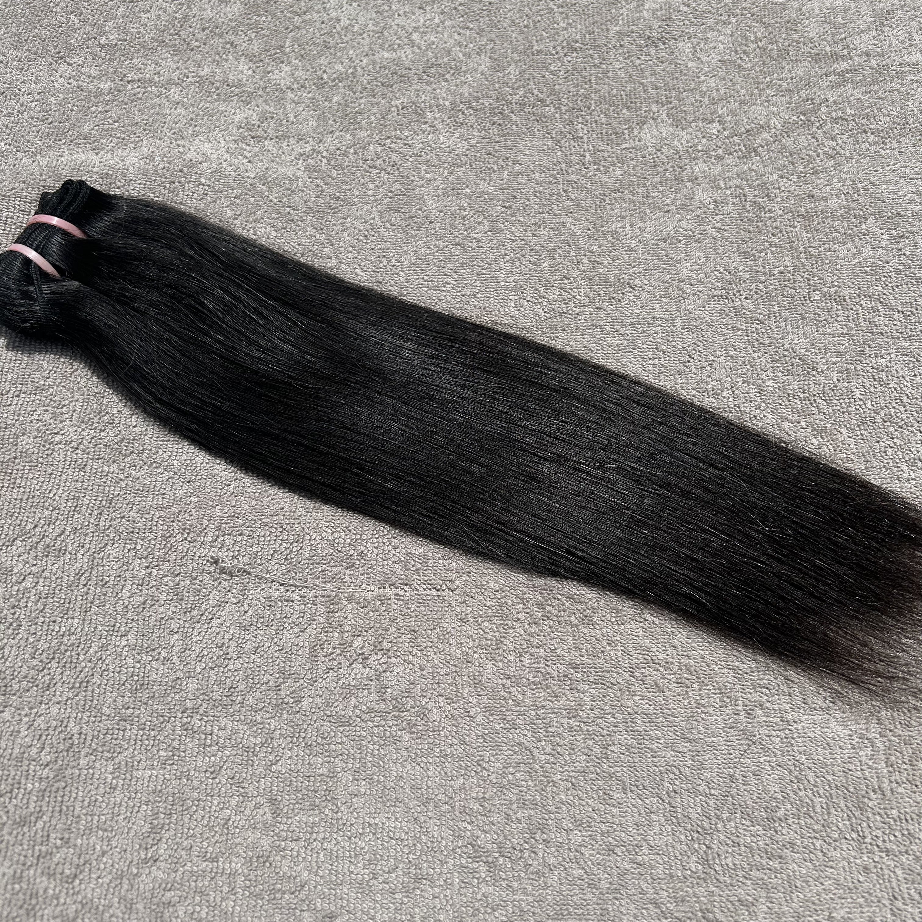 Black hair bundle on a gray surface